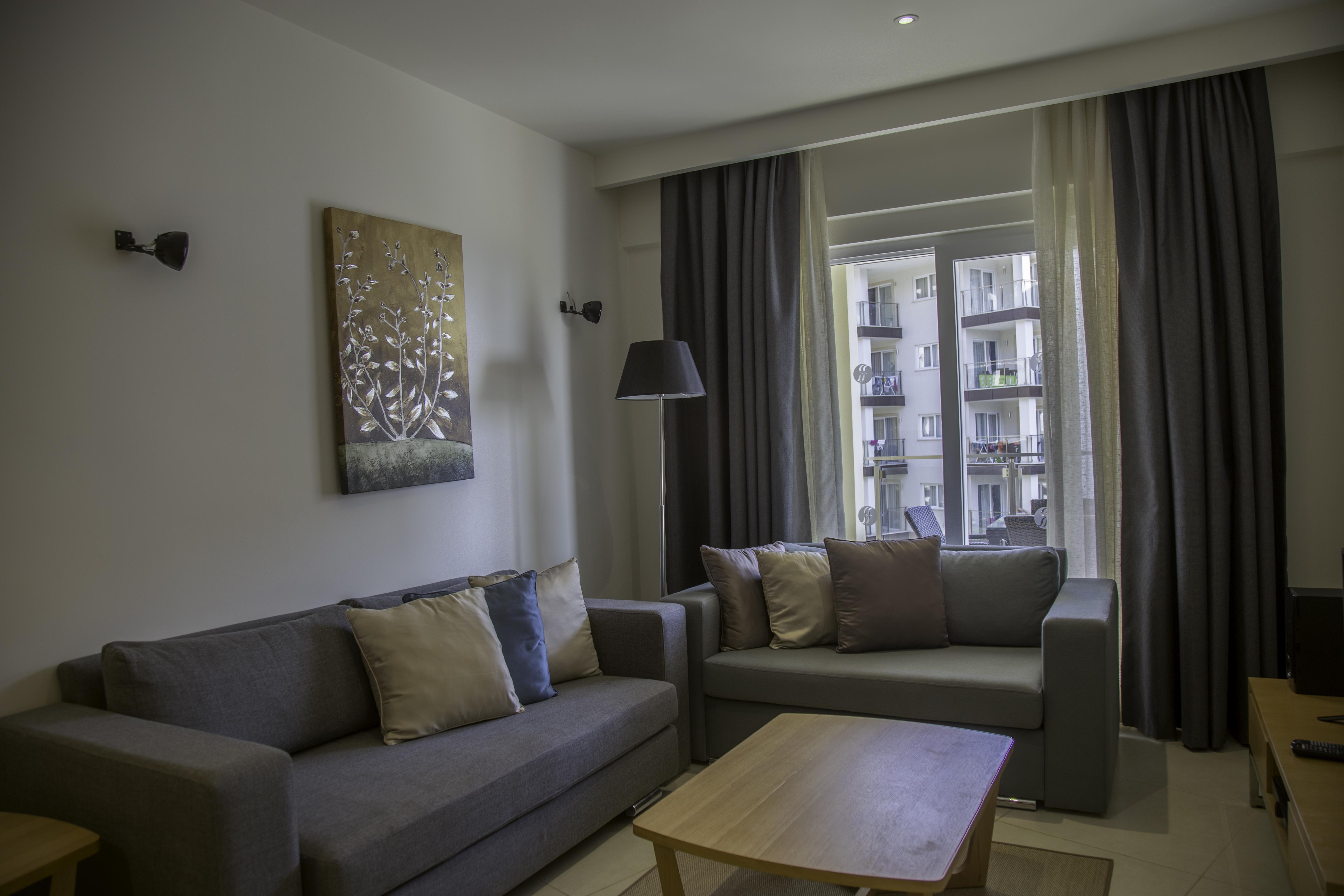 Ramada Resort Kusadasi & Golf Exteriér fotografie A living room in a serviced apartment in Bucharest, Romania